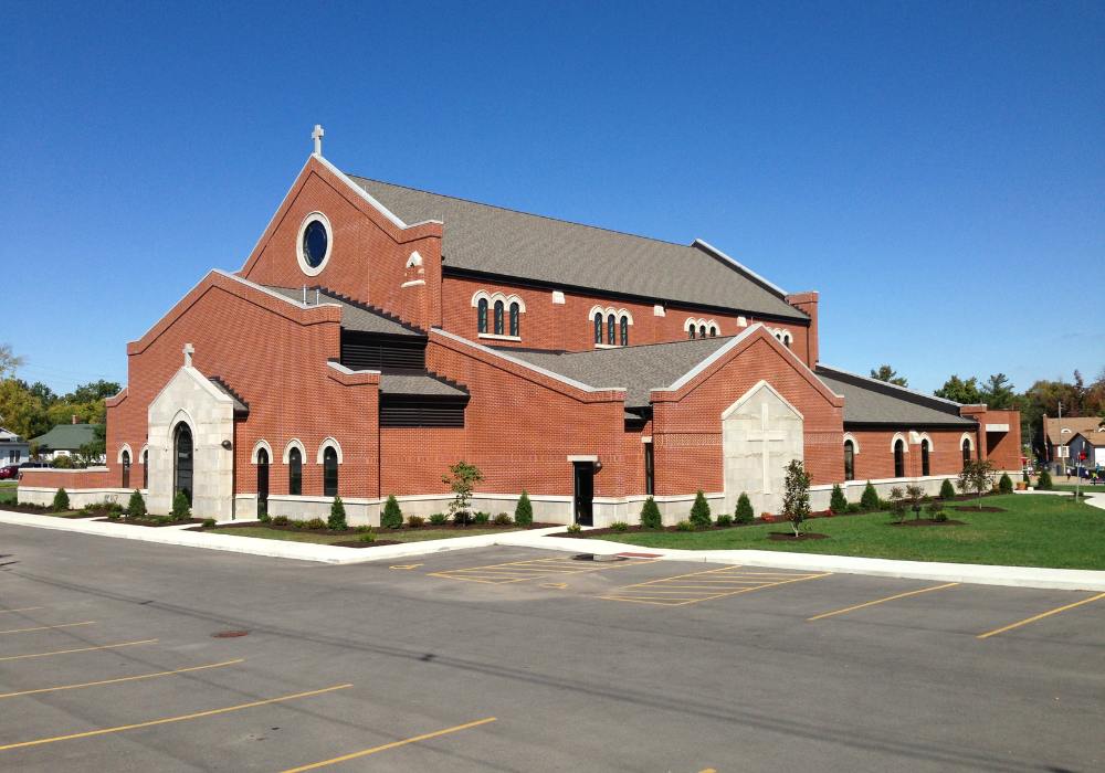 exterior of a catholic church with red brick