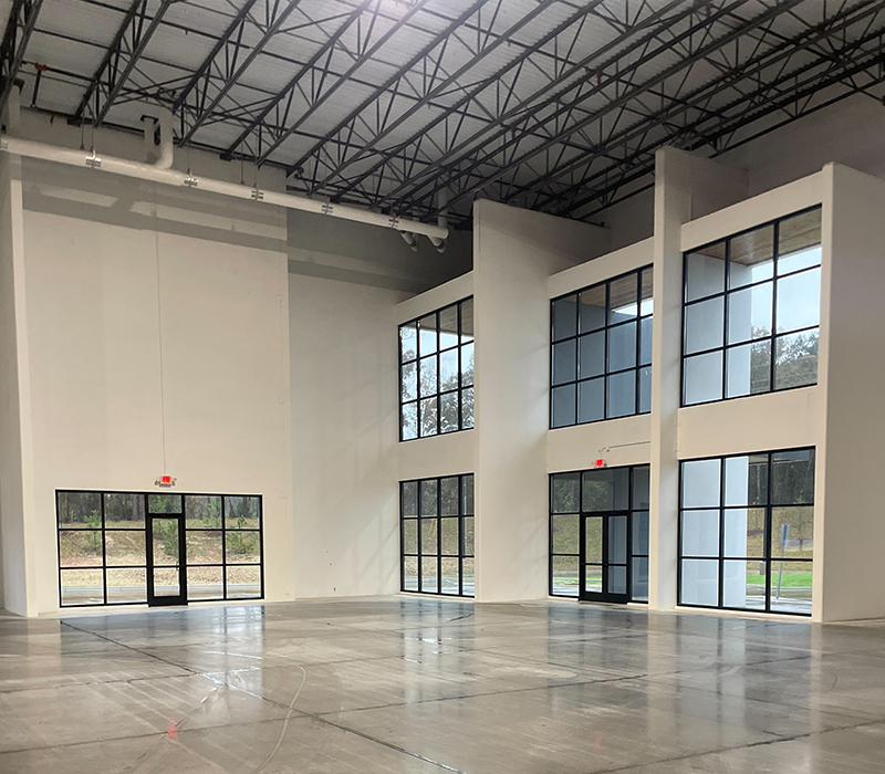 Interior of a large warehouse building with windows