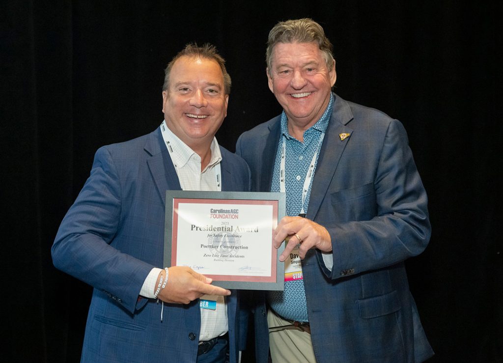 Two men hold a certificate