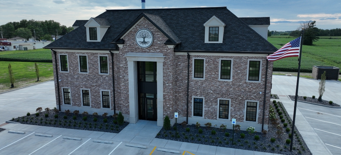 Exterior of multi-story, brick bank with clock above the main entrance