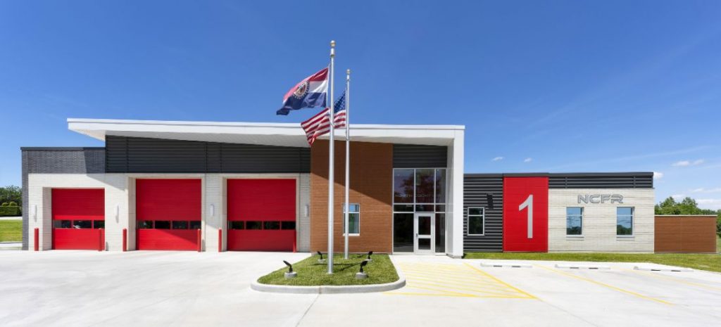 Exterior of a fire department with three garage doors