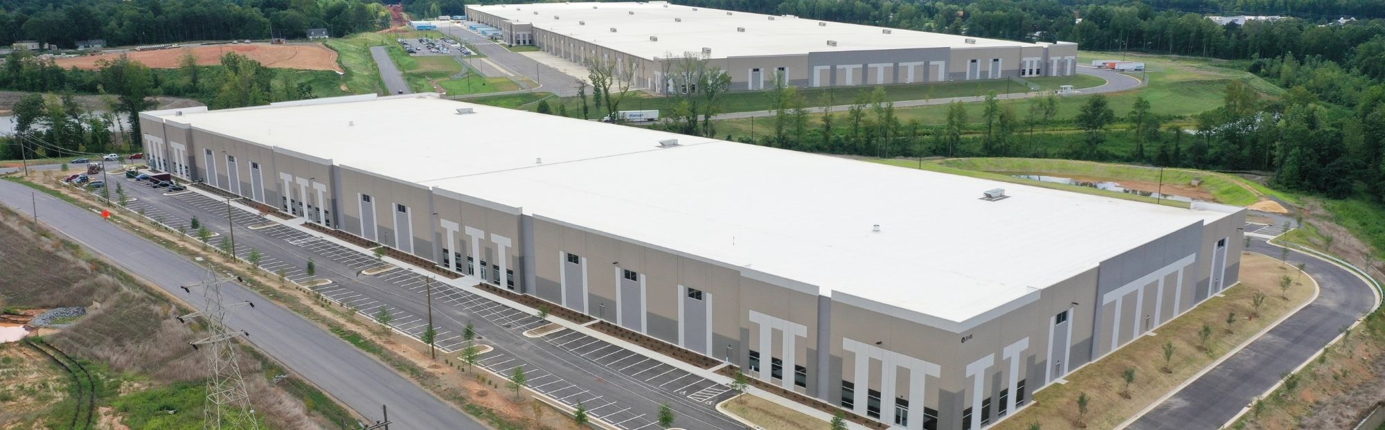 Gateway 85 Bldg 4&7_Website Hero_2000x621 A gray distribution center with white framing around the windows