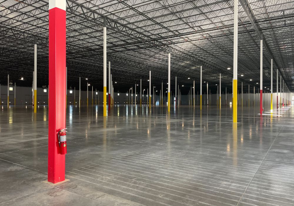 Interior of a distribution center with many white and yellow posts