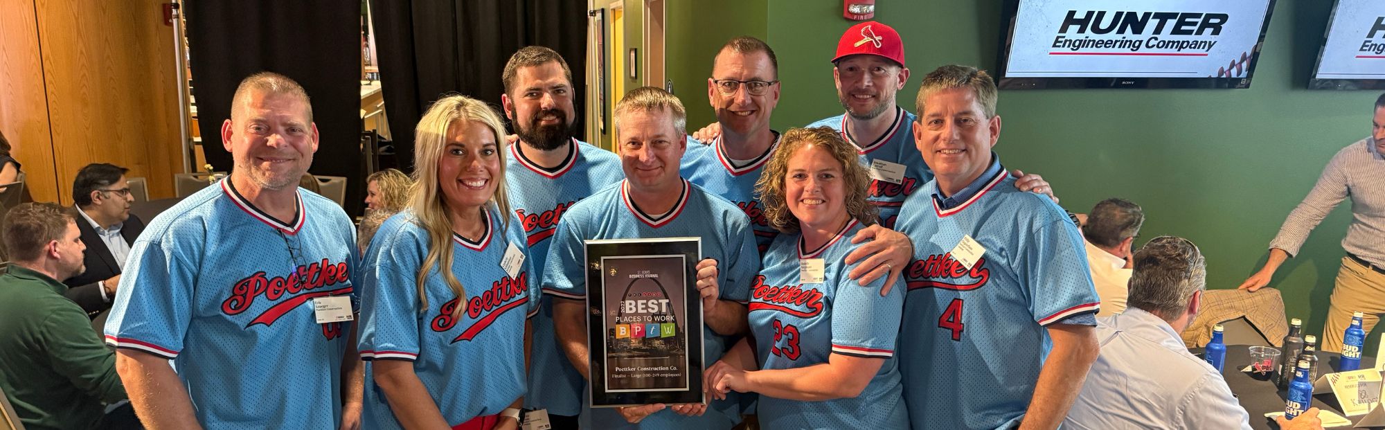A group of women and men in light blue St. Louis Cardinals jerseys