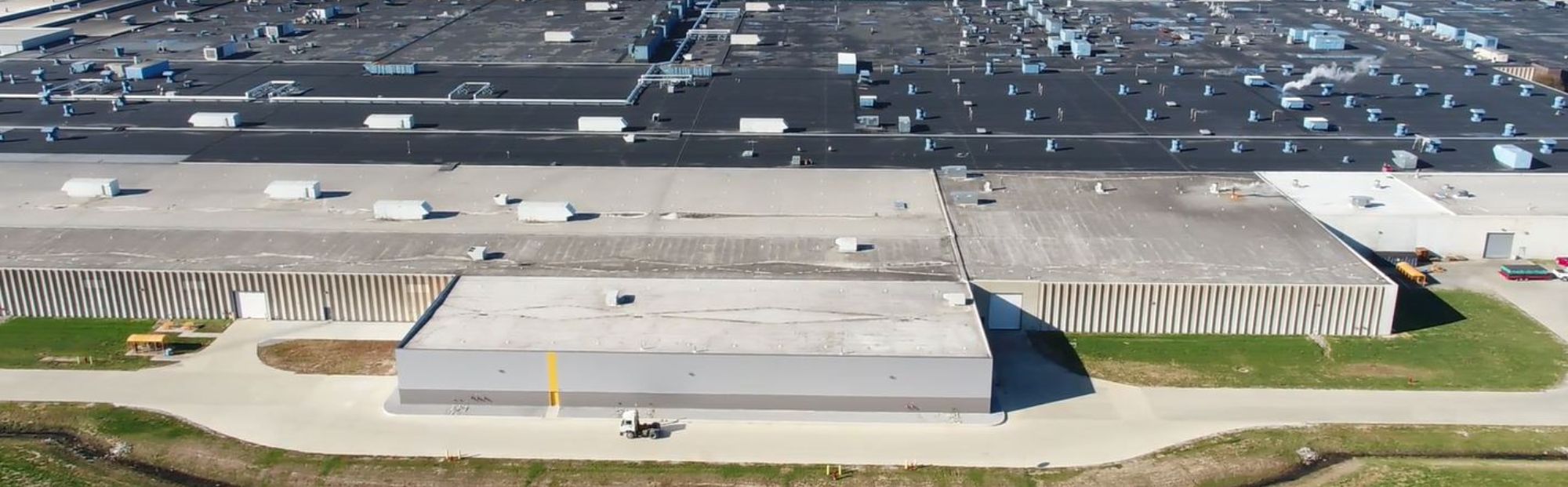CTtA CVT Max Building_Website Hero_2000x621 Aerial view of a sprawling industrial facility