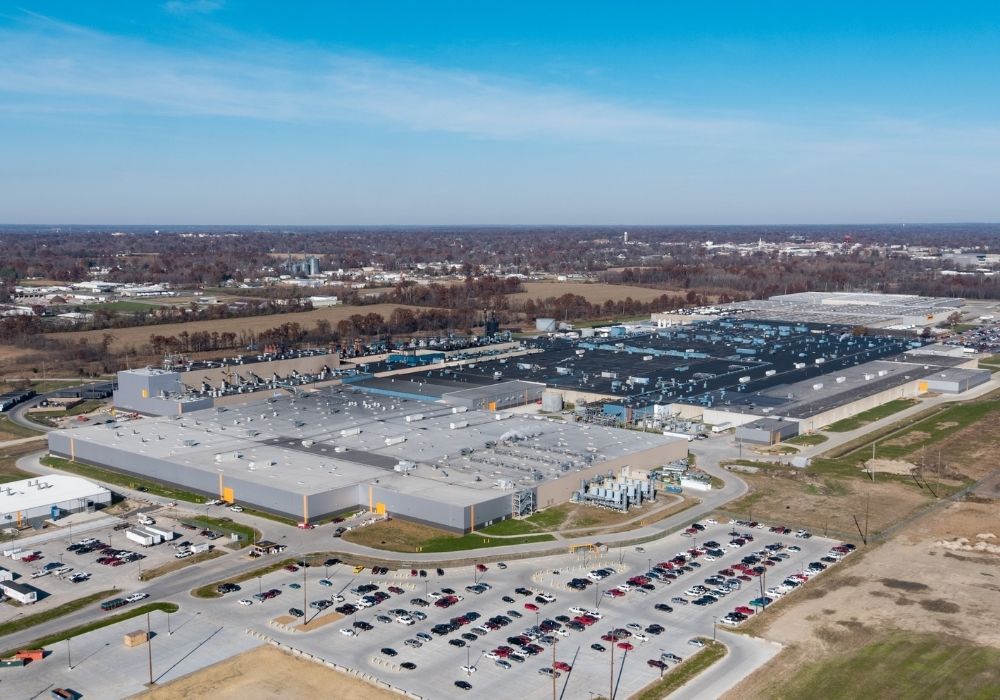 Aerial view of a large industrial facility with a parking lot