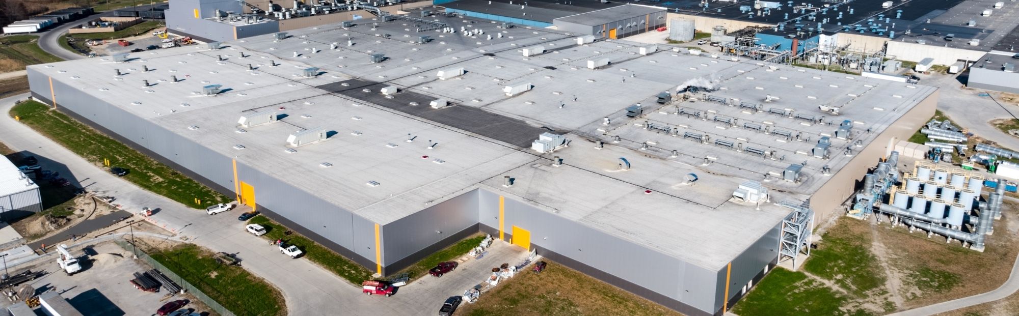 CTtA Plant IV Expan_Website Hero_2000x621 Aerial view of a huge industrial building complex