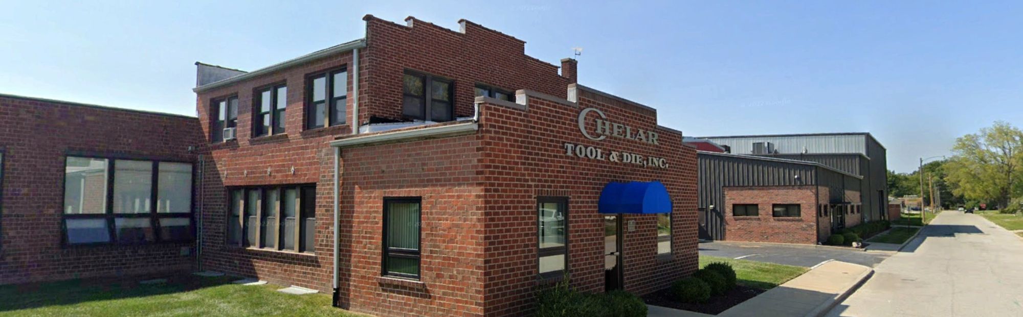 Exterior of brick building with black trim around the windows