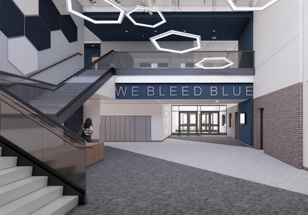 Columbia HS Add & Reno_Website Body_1000x700_1 Digital rendering of a high school entrance that reads "we bleed blue"
