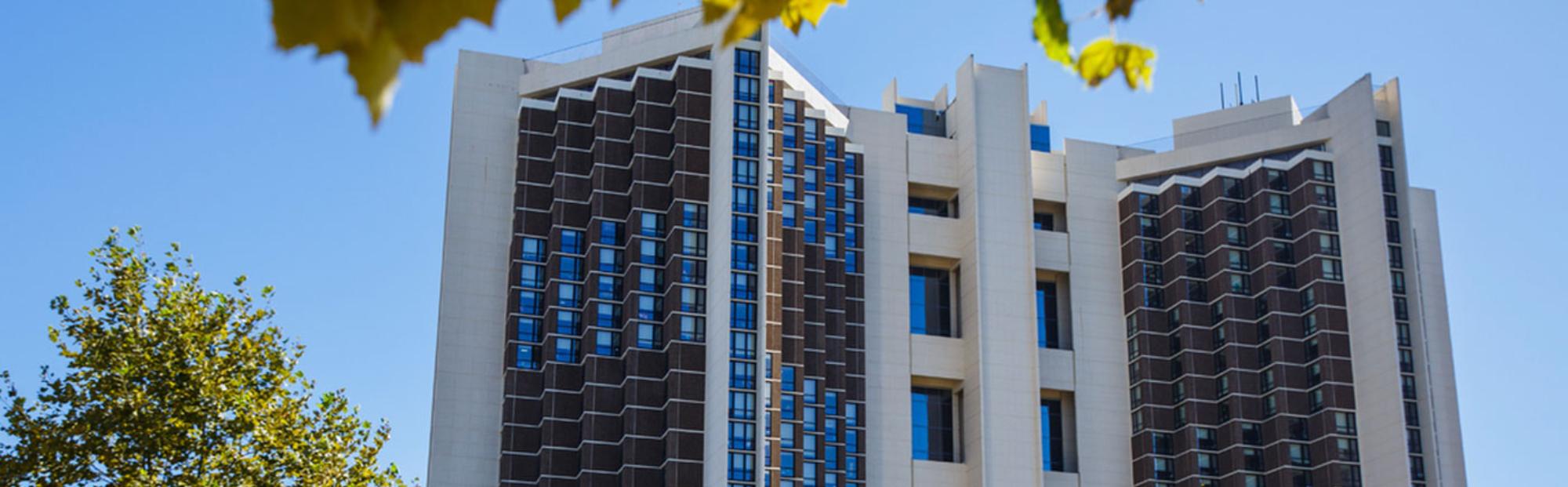 ISU Watterson Towers_Website Hero_2000x621 An image of a multi-story dormitory on a bright sunny day.