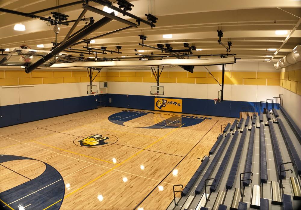 Interior of a school gymnasium with the bleachers pulled out