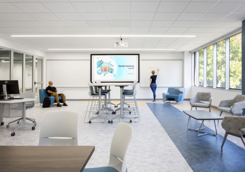 Modern classroom with many windows, glass walls, and a digital board