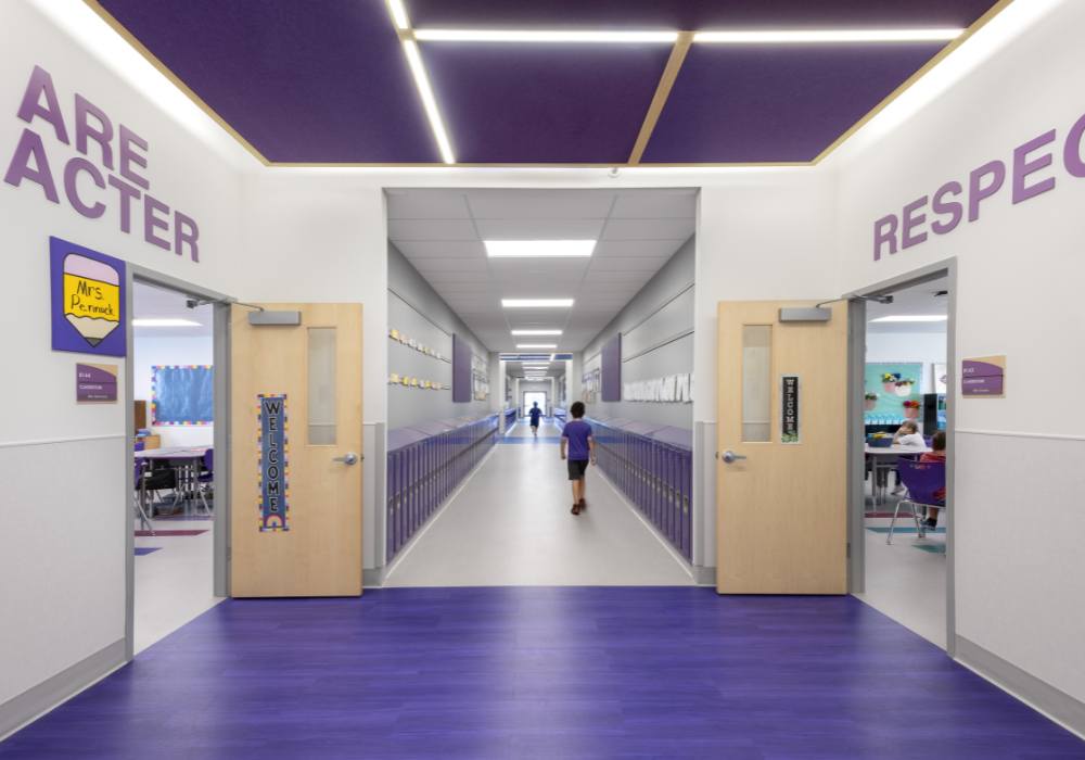 Litchfield ES_Website Body_1000x700_1 Children walking down an elementary school with purple lockers