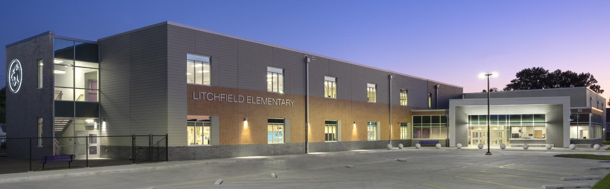 Litchfield ES_Website Hero_2000x621 Exterior of a 2-story elementary school in front of a purple sky