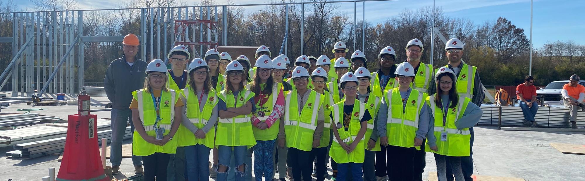 NextGen_Header_JAMS A group of children wearing high-visibility construction vests and white hats