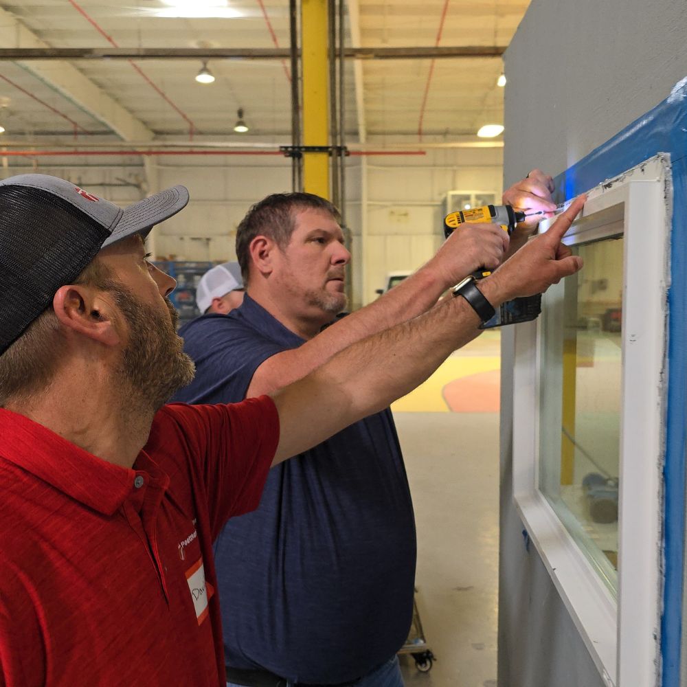 Quality_Body_Building Enclosure Training 2024 Two men install a window