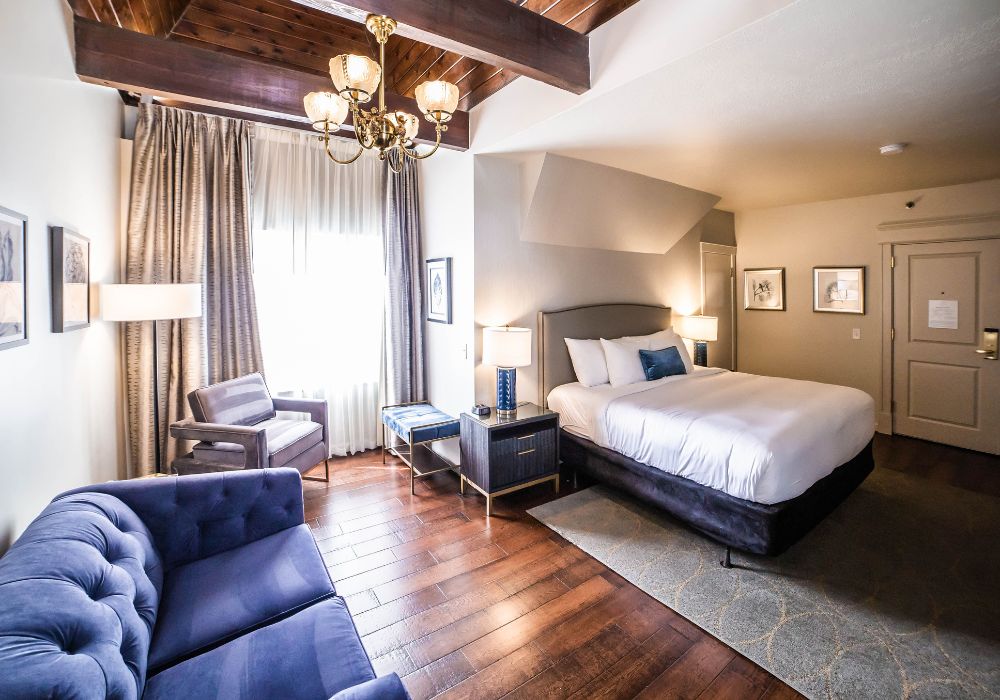 Cozy single bed hotel room with historic wood beams.