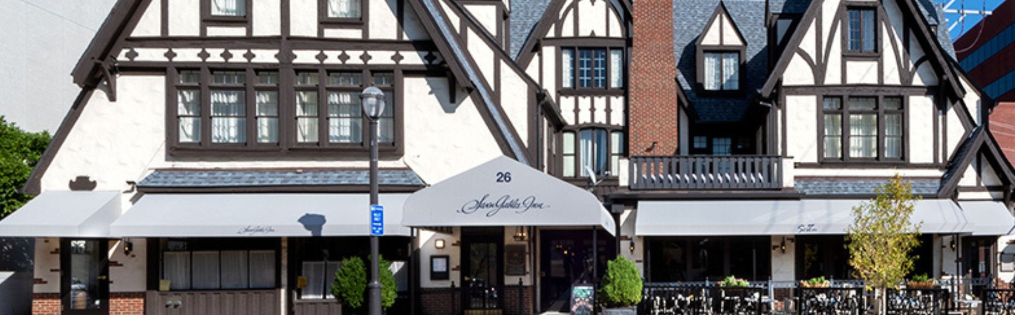 Seven Gables Reno_Website Hero_2000x621 Close up of a historic tudor style hotel