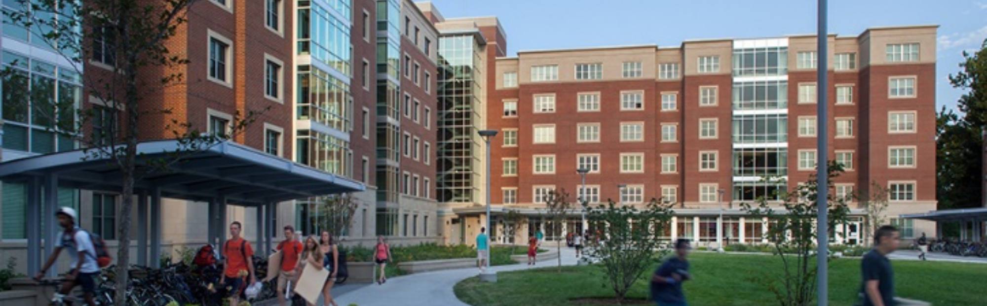 UIUC Bousfield_Website Hero_2000x621 Close-up view of a brick dormitory with glass accents