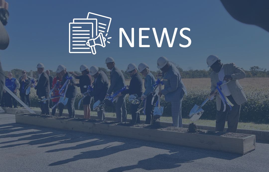Businesspeople wearing construction hats shovel dirt