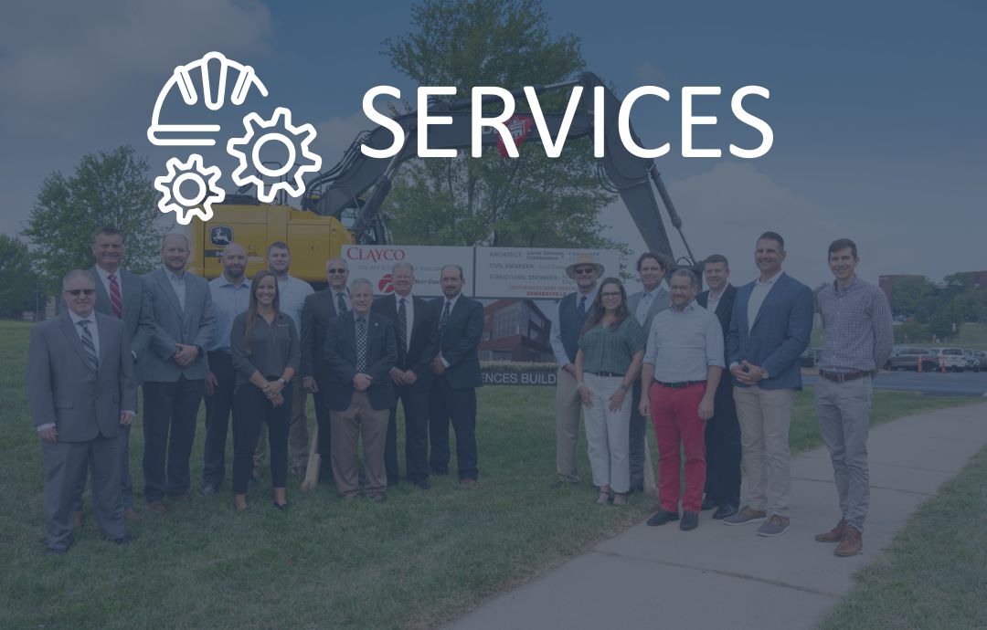 Businesspeople standing in front of construction equipment
