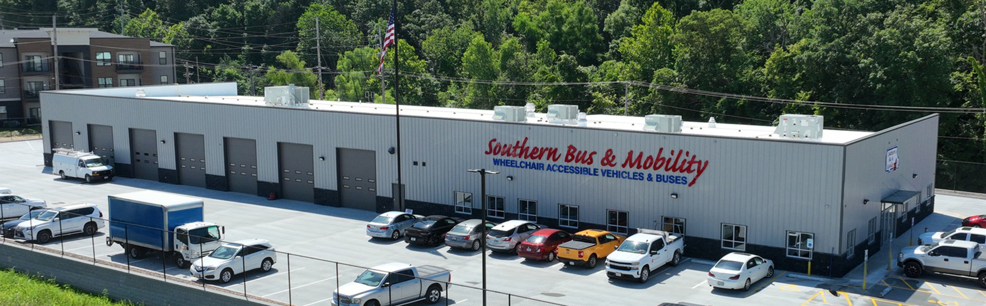 Southern Bus & Mobility_100-2025-07-Hero A long white building with seven garage doors