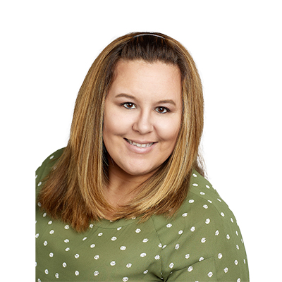 A woman with light brown hair and a polka-dot green shirt
