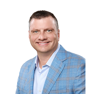 A smiling man in a blue plaid blazer