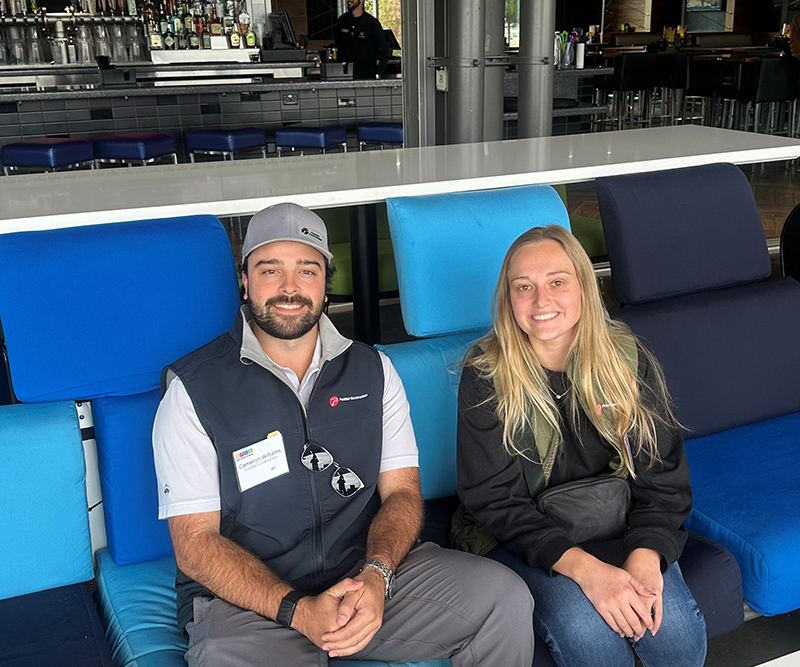 A man and a woman on a light blue and dark blue couch