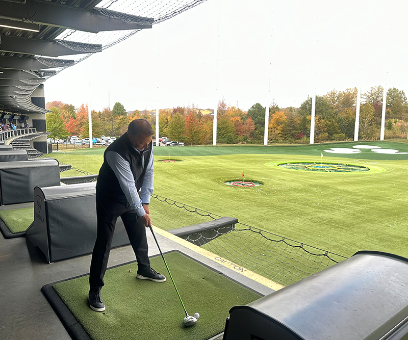 A man with a golf club lines up his shot