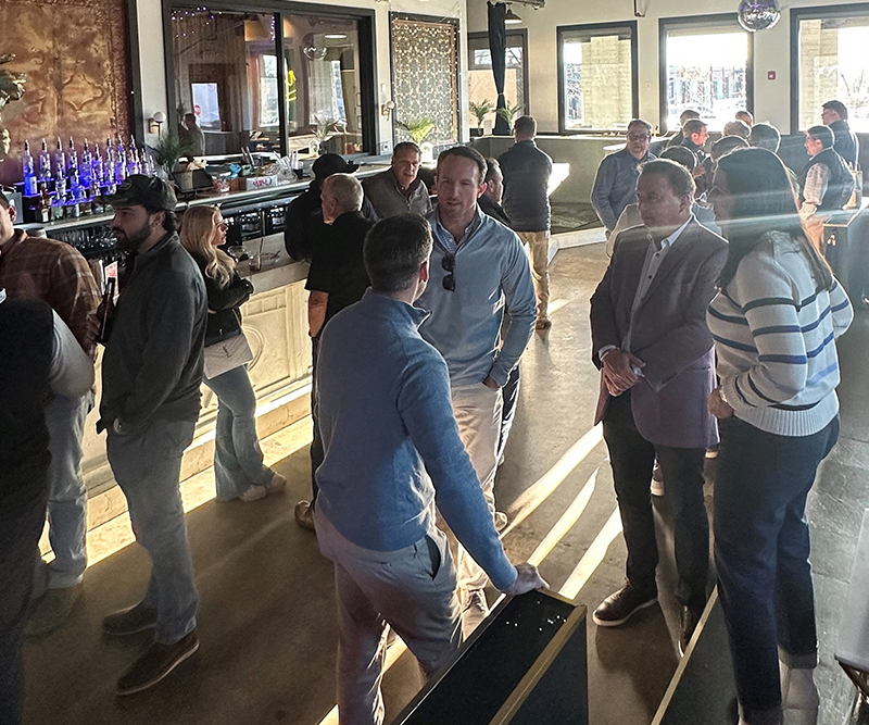 Men and women mingle at a bar