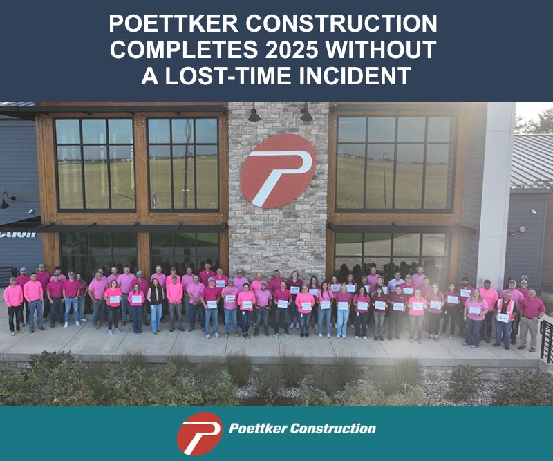 Men and women wearing pink shirts and standing outside of a corporate headquarters