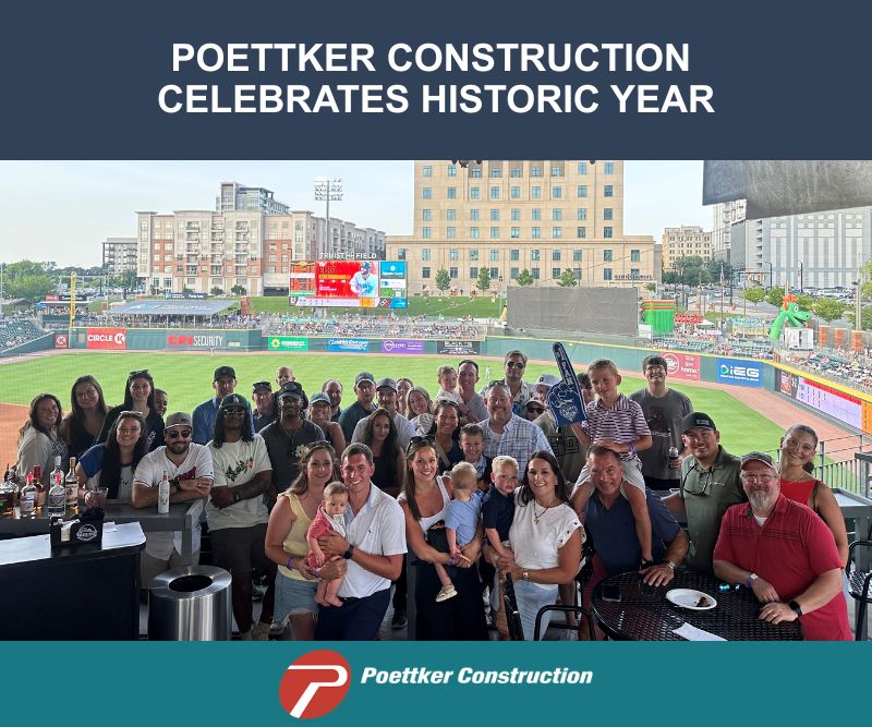 A group of men, women, and children at professional baseball stadium