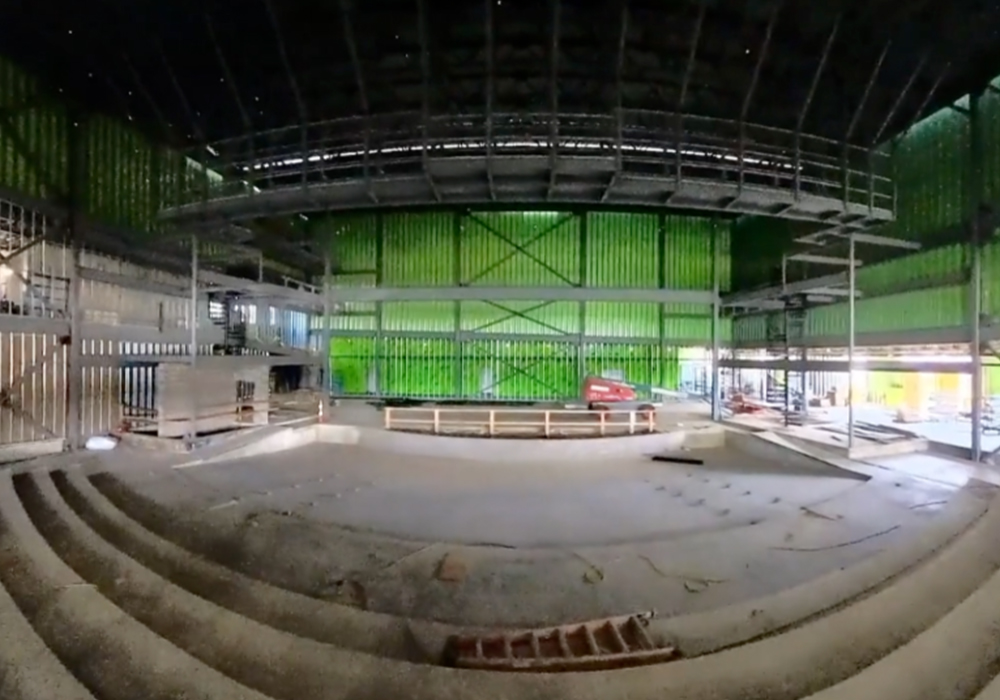 Columbia HS Aud_500_2025-09-12_091548-1000×700 Fish-eye view of a concrete high school auditorium under construction