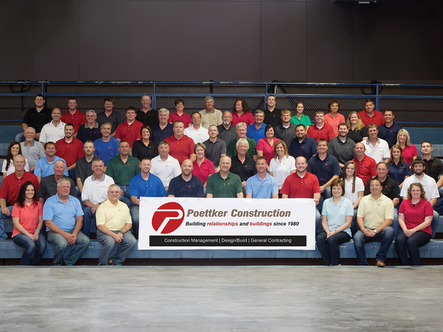 Men and women in collared shirts sitting on blue bleachers