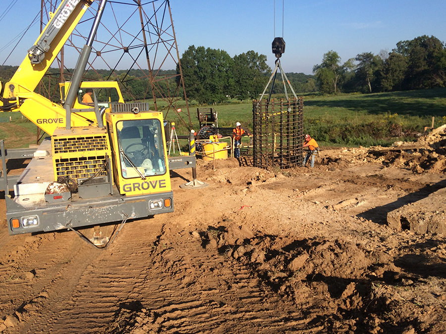 Heavy machinery and workers in hard hats at a construction site