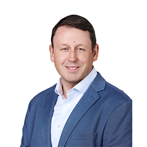 A Caucasian man in a blue blazer smiling