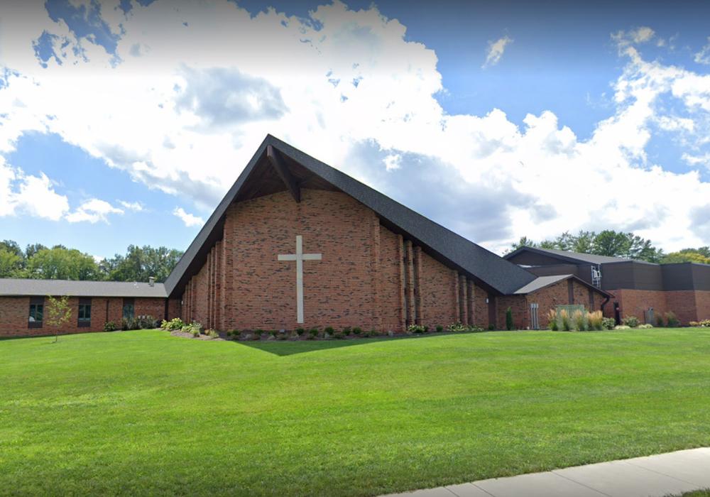 church exterior with brown brick and a large cross