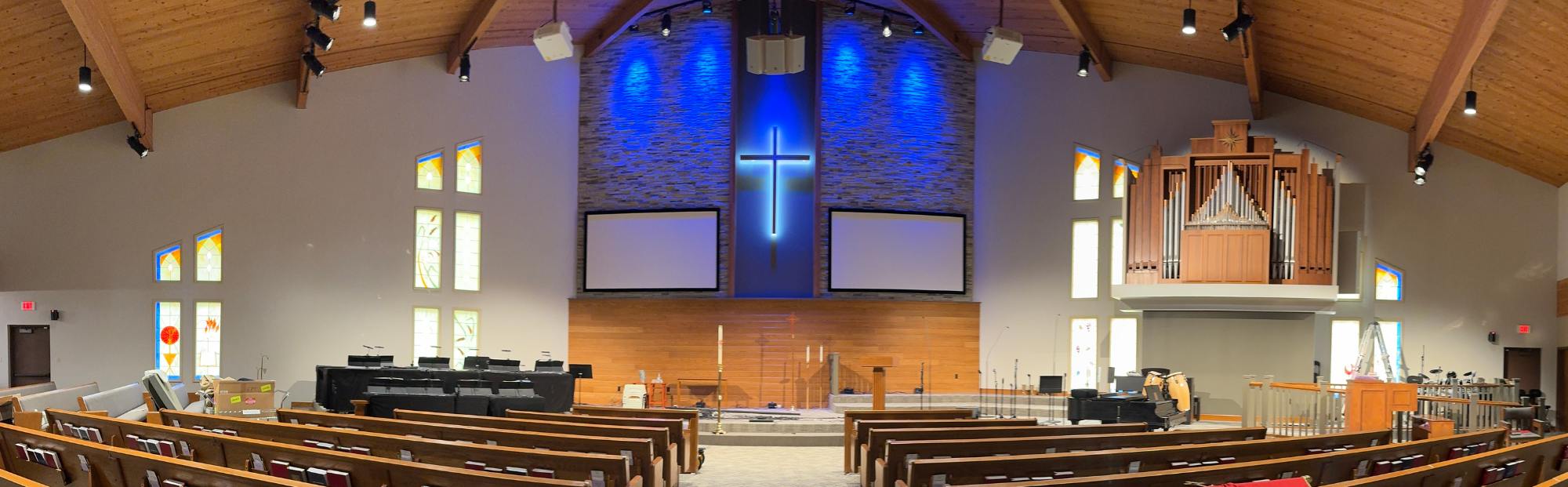 church interior with pews and a large cross