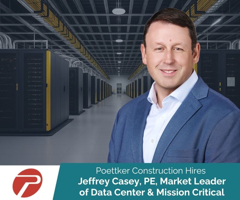Smiling man in front of a data center hallway