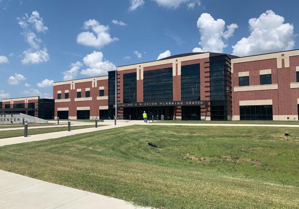 two-story red brick building with black windows
