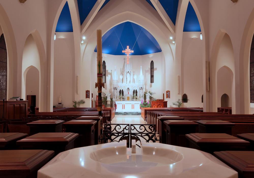 St. Kateri_Website Body_1000x700 (4) interior of a church with pews and vaulted ceilings