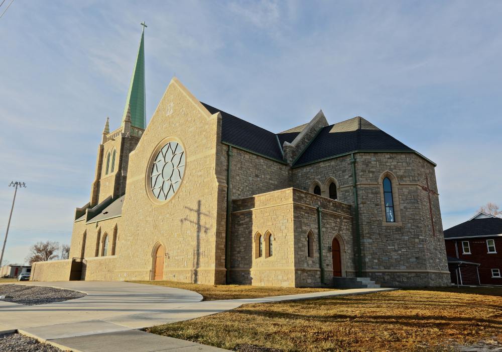 St. Kateri_Website Body_1000x700 exterior of a church with light tan brick