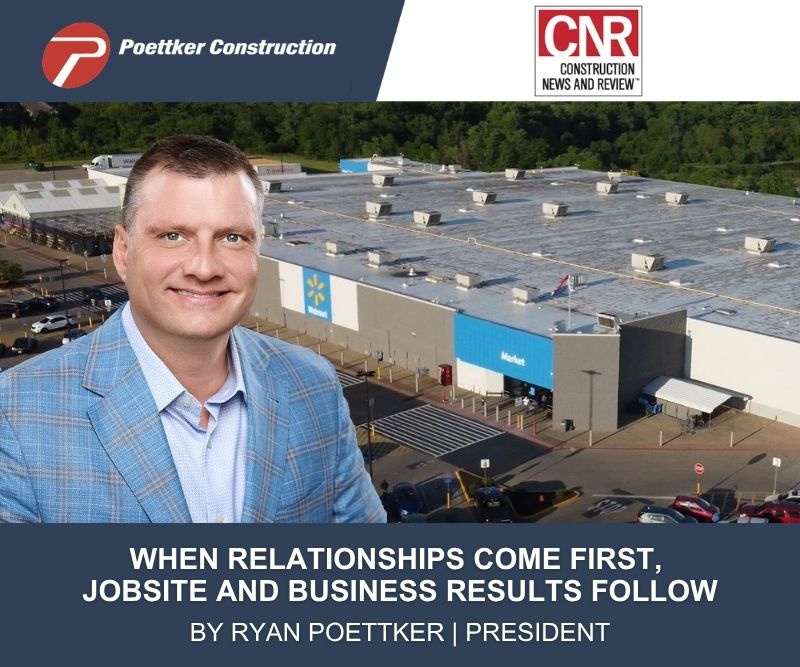 A smiling man in a plaid sports coat in front of a Walmart