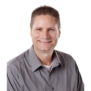 A smiling man with a crew cut