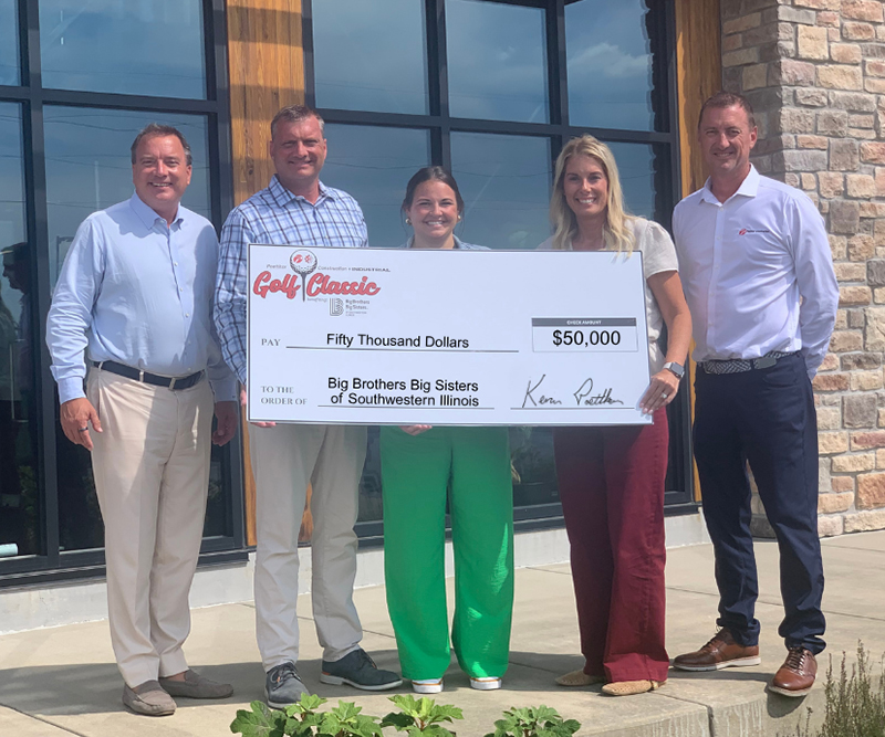 Four adults present a giant check to a woman