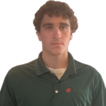 A young man in a green collared shirt